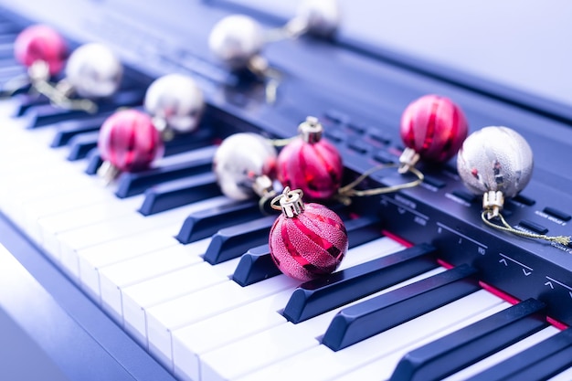 Piano keys with Christmas decorations, closeup