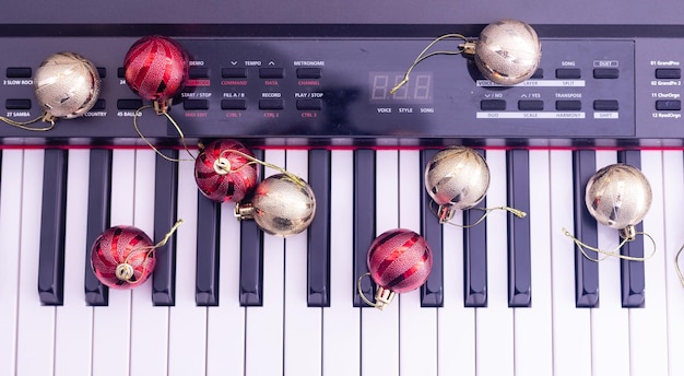 Piano keys with Christmas decorations, closeup