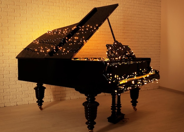 Piano with Christmas lights in empty room