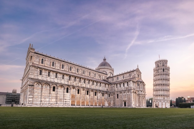 Piazza del Duomo with Leaning Tower and Cattedrale di Pisa against sunrise colorful sky Pisa Italy