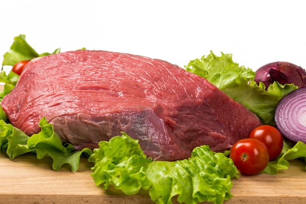 Pice of fresh raw meat with vegetables