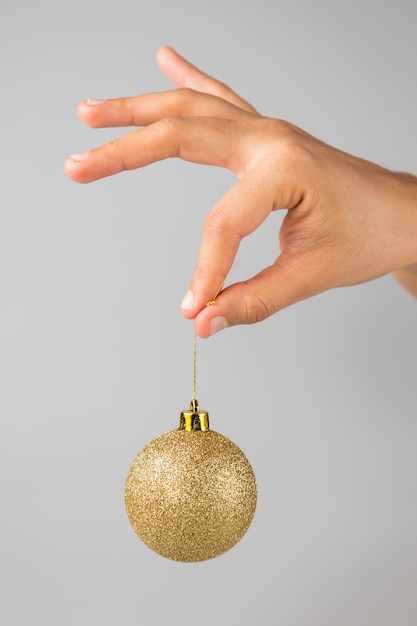 Picking a christmas balls isolated in gray background