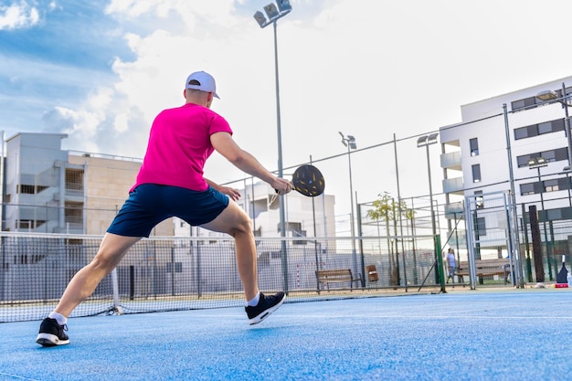 pickleball player running and stretching to get to hit the ball during a game