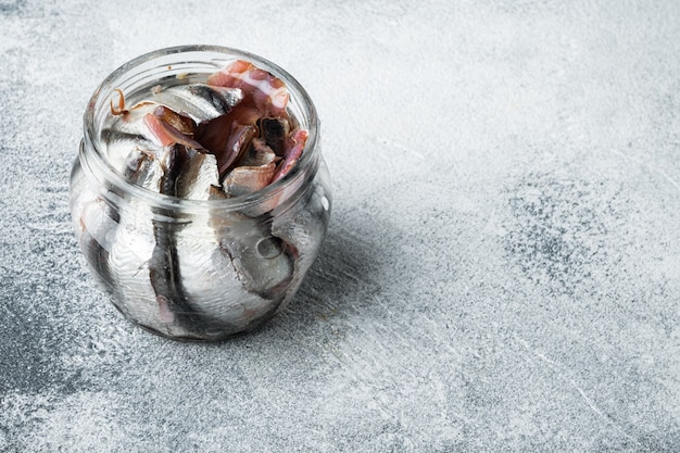 Pickled Anchovy set, in glass jar, on gray