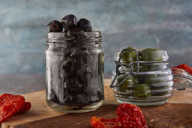 Pickled black olives in a glass jar