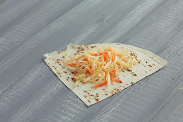 Pickled cabbage and pita bread on the wooden table