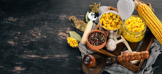 Pickled corn in a jar Stocks of food Top view On a wooden background Copy space