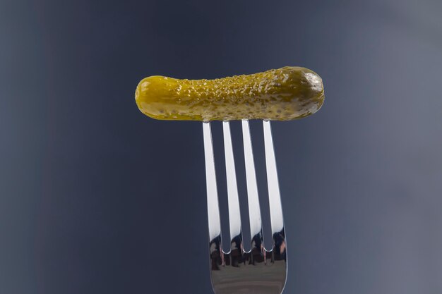 Pickled cucumber on a fork. food and vegetables