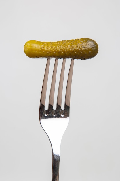 pickled cucumber on fork.