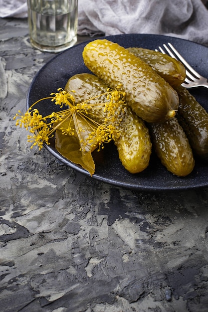 Pickled cucumbers in black plate