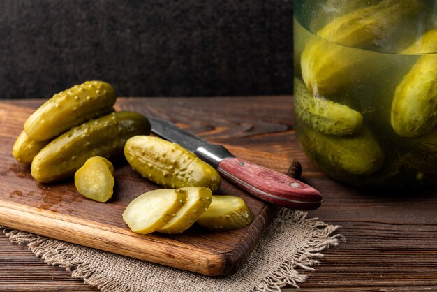 Pickled cucumbers on a dark wooden table