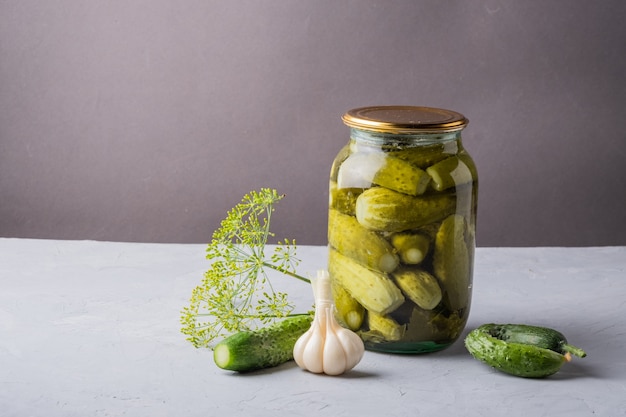 Pickled cucumbers in the jar Ingredients for pickling cucumbers Cucumbers dill garlic Glass jar