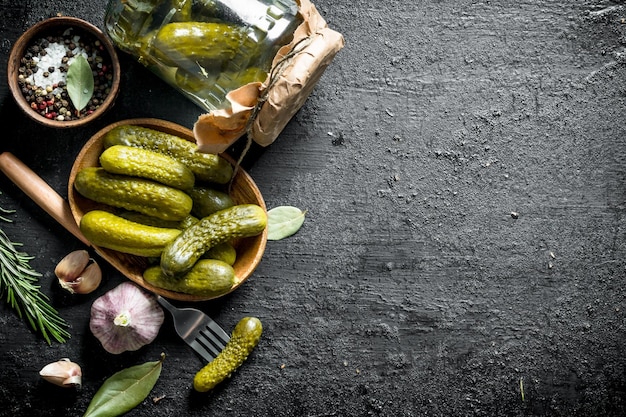 Pickled cucumbers on a plate and in a glass jar