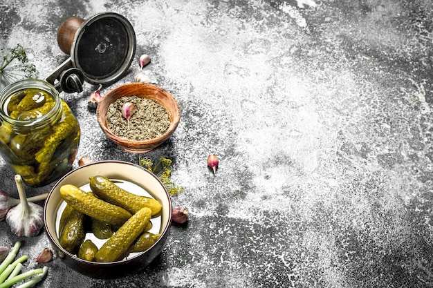 Pickled cucumbers with seamer. On a rustic background.