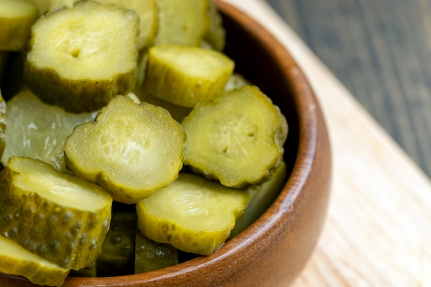 Pickled cucumbers on a wooden table during cooking