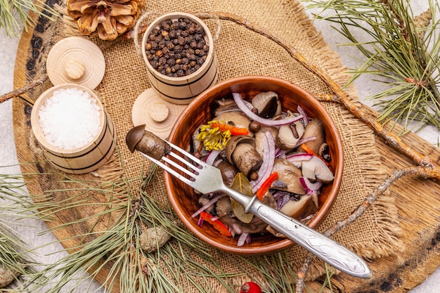 Pickled or fermented mushrooms. Traditional Christmas snack. New Year Festive cutlery