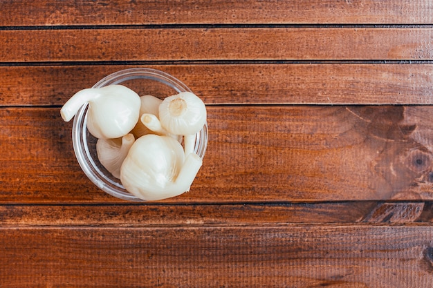 Pickled garlic on a brown background