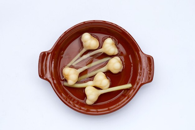 Pickled garlic on white background.