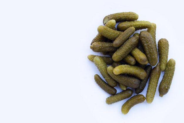 Pickled gherkins or cucumbers on white background.