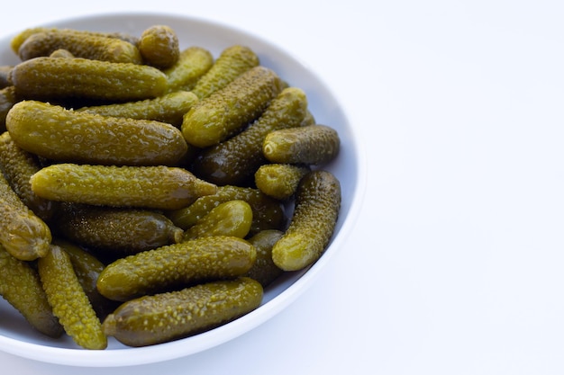 Pickled gherkins or cucumbers on white background.