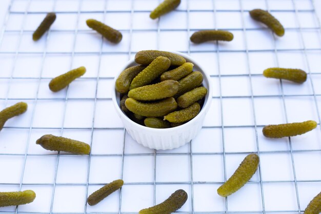 Pickled gherkins or cucumbers on white background.