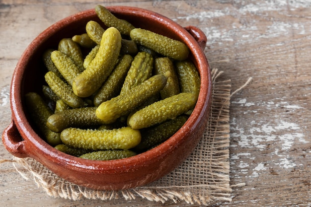 Pickled gherkins on rustic background