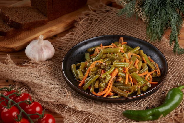 Pickled green bean pods on wooden