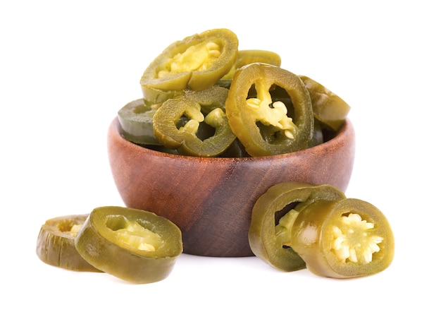 Pickled jalapeno pepper in wooden bowl isolated on white background slices of preserved hot serrano