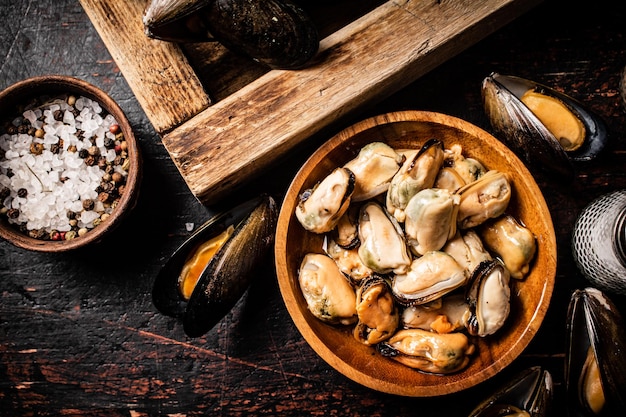 Pickled mussels in a wooden plate on the table