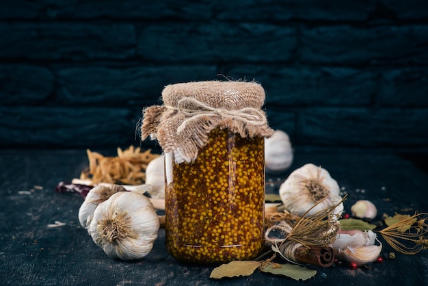 Pickled mustard in a jar Stocks of food Top view On a wooden background Copy space