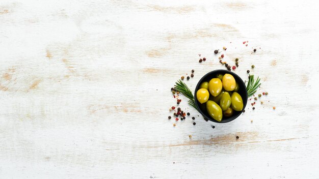 Pickled olives in a black bowl Top view Free space for your text