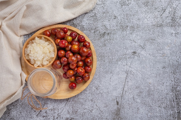 Pickled Plums on the dark surface.