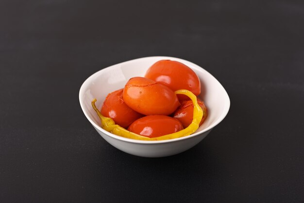 Pickled red tomatoes with chilli in a plate