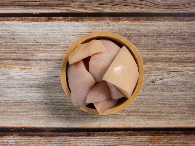 The  pickled santol  in bowl on wood table for food content.