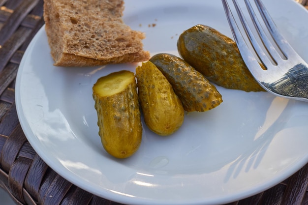 pickled sliced cucumbers a piece of rye bread