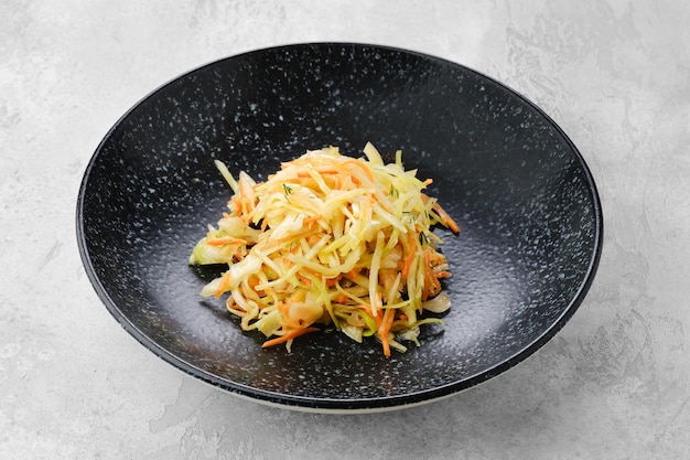 Pickled slices of cabbage and carrot on a plate