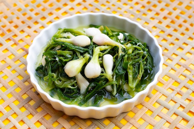 Pickled spring onion in white bowl