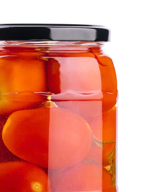 Pickled tomatoes in glass jar on white background