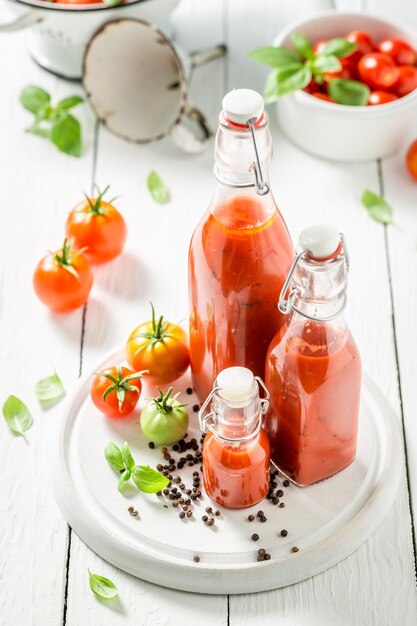 Pickling red tomatoes at home Passata in jar with herbs