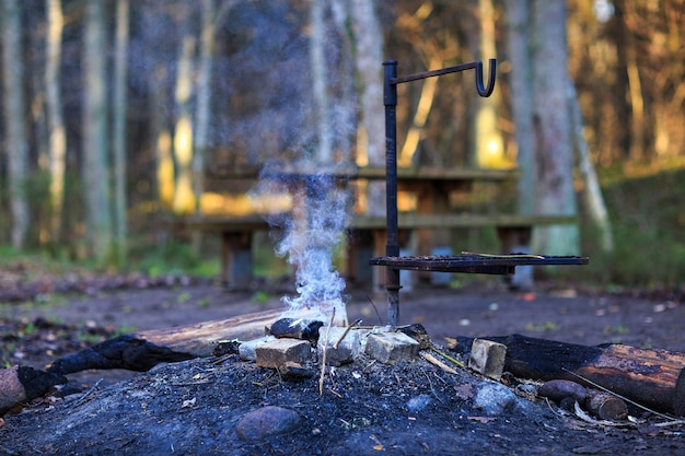 Picnic area in the woods and fire smoke