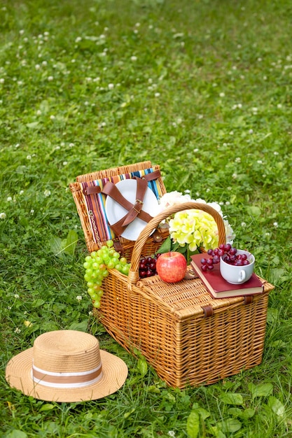 Picnic basket on green grass copy space