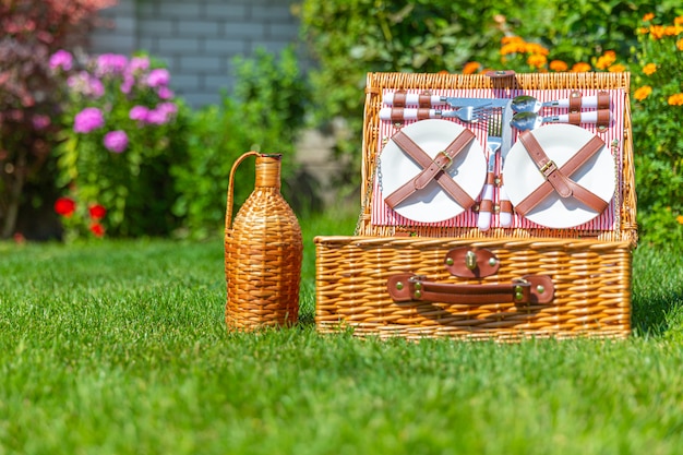 Picnic basket  on green sunny lawn in the park