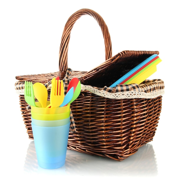 Picnic basket with fruits and tableware isolated on white