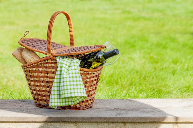 Picnic basket with wine and baguette