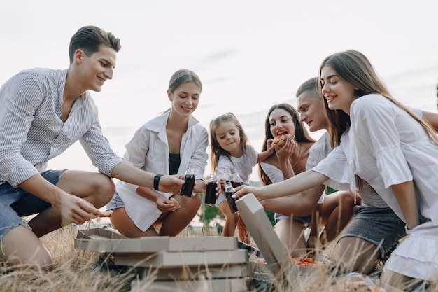 Picnic friends with pizza and drinks