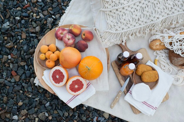 Picnic on the lake shore, a blanket with a basket, fruit and juice