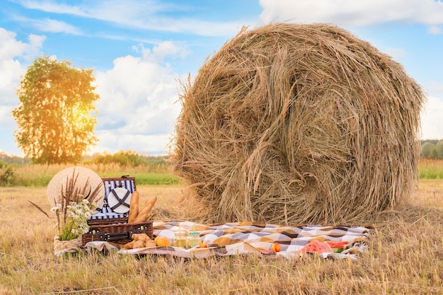 Picnic in nature in a field near a round haystack photo zone decoration