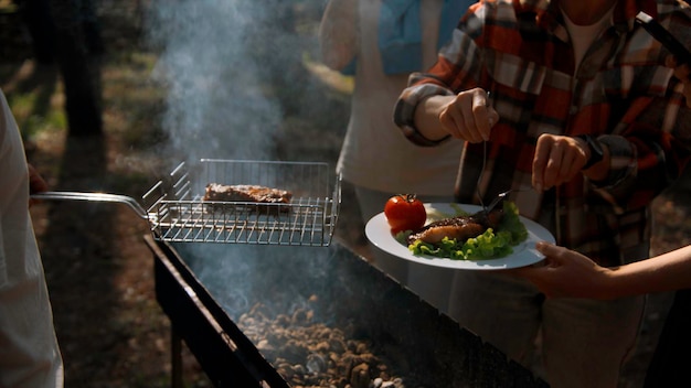 Picnic in nature in the woods bbq over a campfire with smoke stock footage man putting delicious