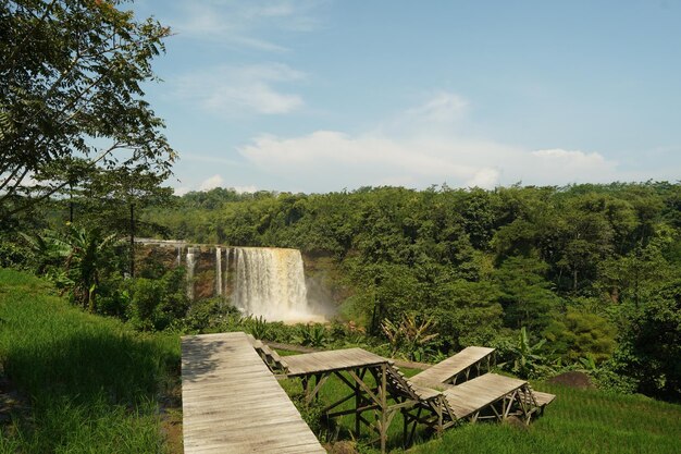 A picnic table in front of a waterfall