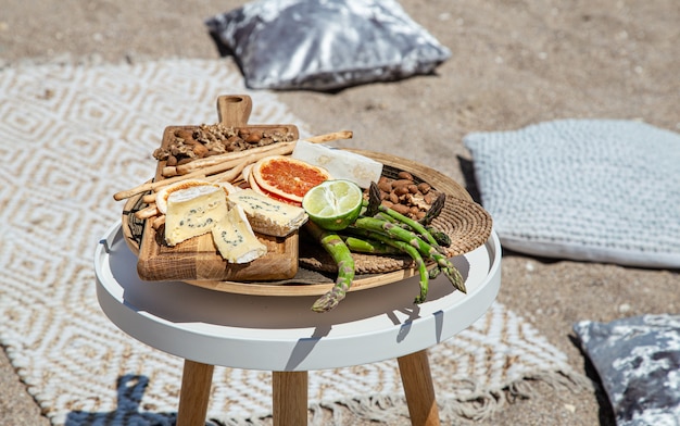 Picnic with delicious beautiful food on the table close up. Outdoor recreation concept.